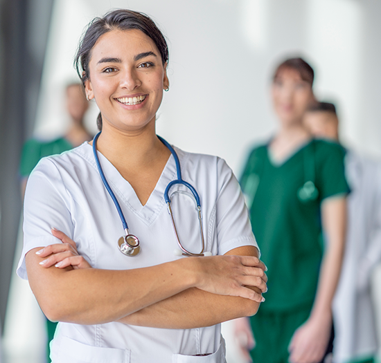 Tulane nurse smiling with team behind her