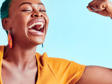 Woman laughing and showing muscles